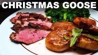 Roast goose with Christmas spices, black cherry gravy, goose-fat roast potatoes and mustard greens