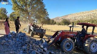 Massoud going to work and compacting the occupations around the hut with an excavator