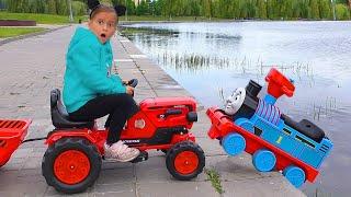 Sofia on toy Tractor Saves the Little Bus on Children's park