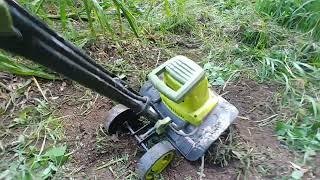 sun Joe electric tiller knocking down out of control weeds in the garden