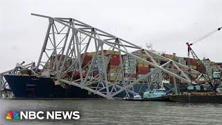 Workers create narrow channel through destroyed Baltimore bridge