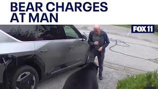 Bear charges at man in his garage