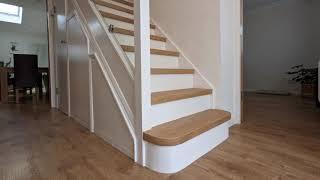 Engineered oak stair cladding with modern white painted risers uplifts family home, Epping Forest E4