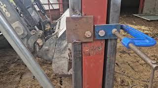 Farmer fabricating new diagonal feed barriers