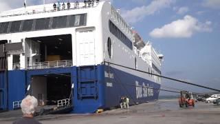 BlueStar Ferry docking in Port Rhodos in stormy weather with rope demolition