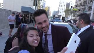 Brett Dalton greets fans while arriving at the American Ultra Premiere at Ace Hotel in Los Angeles