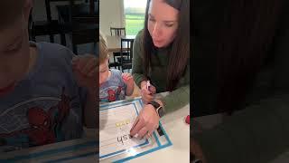 Watch as I guide my three-year-old through writing his name using a dry erase pocket