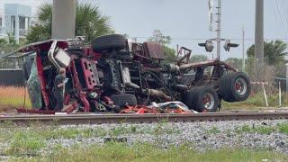 Train collides with fire truck in Florida; police say 3 firefighters and several passengers hurt