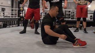 Bin Wang practices kip-ups at the WWE Performance Center