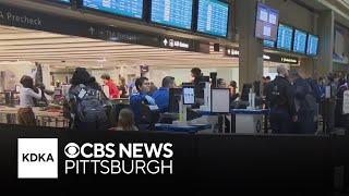 Holiday travelers move through Pittsburgh International Airport