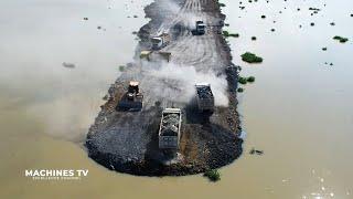 Stunning View New Road Building Technology Over Big Lake Bulldozer Spreading Stone Dump Truck Moving