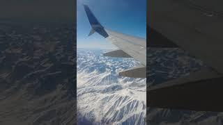 snowy sierra. full airplane window view video on the channel! #snow #mountains #shorts