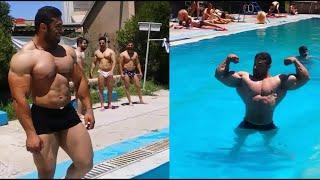 Iranian bodybuilder Behrooz Tabani diving in the pool and showing a double biceps pose