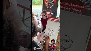 Super shy young lady gets caricature drawn by Alani J