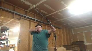 shooting a vintage 1970s Bear B wood riser takedown recurve bow.