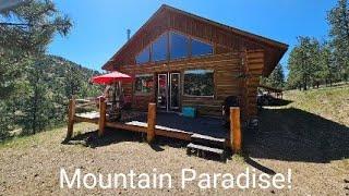 Off-Grid log cabin in the Colorado Mountains for sale.  Drone video of the property in description.