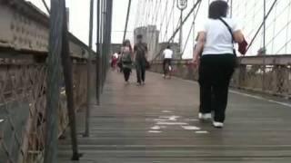 People walking across Brooklyn bridge