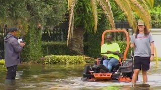 ‘That’s America!’ Florida man catches fish in middle of flooded road after Milton passes through