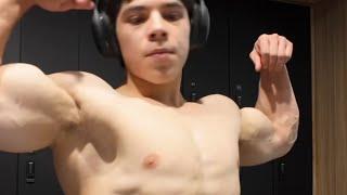 16 years old teen boy flexing muscle