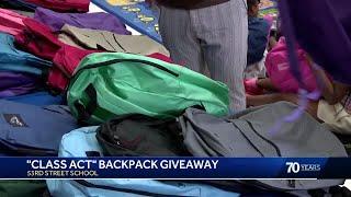 Smiles and hugs as kids receive free backpacks