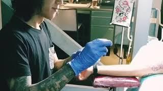 Charlie Evan tattooing Ica's innerarm. Kedai Tato Bahagia studio.