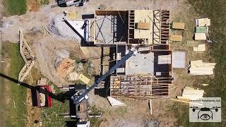 DronEye view of residential construction setting trusses on job site