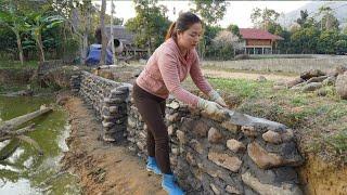 Dung helped the village man build wall around the fish pond using billions of stones