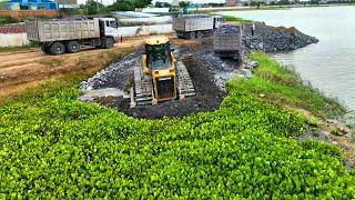 whole project Big Lake being filled with stone! Bulldozer pushing stone, delivering by truck stone