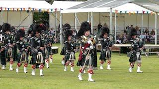 Lonach Pipe Band march & drum display for Beating Retreat at 2022 Lonach Highland Games in Scotland