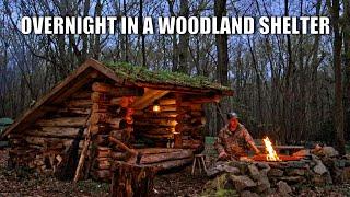 Sleeping in a woodland bushcraft shelter