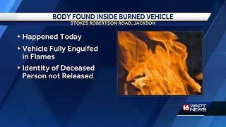 Jackson police investigating a body found in a burned out vehicle