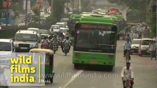 Chaotic traffic moves along a busy road in New Delhi