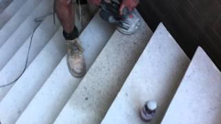 Polishing a concrete step on a staircase