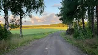 Relaxed biking on dirt roads in south east Finland countryside. Summer evening