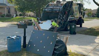 Groot Mack McNeilus Rear Loader Garbage Truck Packing Bulk Waste at the Fall Clean Up