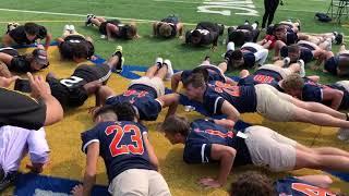 Genesee County sheriff Chris Swanson challenges high school football players to push-up contest