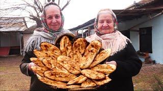 Grandmothers baked beans with walnut and bread on the stove