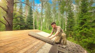 Building a house in the forest. Covered the roof with soft tiles.