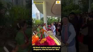 PM #Modi receives warm welcome in #Singapore, tries his hand on '#dhol' #shorts