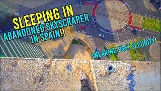 SLEEPING IN SKETCHY ABANDONED SKYSCRAPER IN SPAIN! *SNEAKING PAST SECURITY*