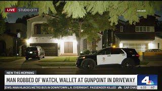 Man robbed of watch, wallet at gunpoint in driveway