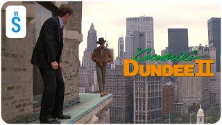 Crocodile Dundee II (1988) | Scene: Dundee walking along the edge of the building