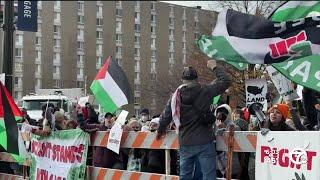 Protesters line parade route in downtown Detroit