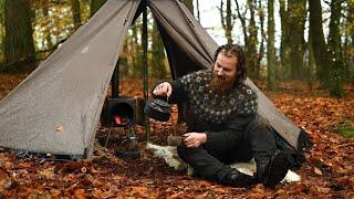 Bushcraft trip - rainy day in a hot tent next to large lake, making firewood and cooking a meal etc.