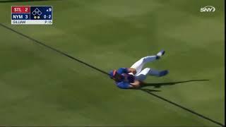 New York Mets outfielder Tim Tebow, trips and falls down while trying to make the game ending catch