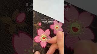 Painting Takashi Murakami cherry blossoms on a Louis Vuitton Pochette Voyage Etui