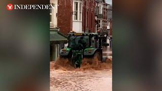 Tractor creates devastating wave by driving through flooded UK town