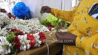 Flower Market in Bangalore, with garlands being made: Come here for Tuberose garlands, marigold, etc