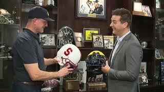 Jim Harbaugh shows off broken helmet from Michigan LB Michael Barrett