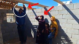 Family project:joint effort mother and her daughters building kitchen ceiling with help master